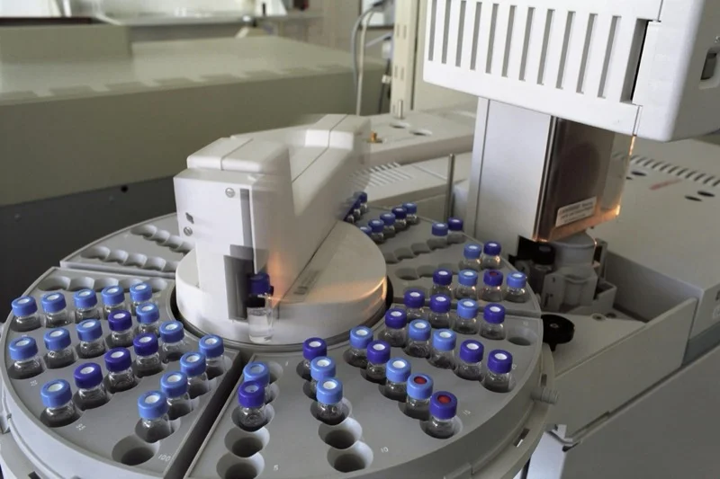 Laboratory analyser carousel holding rows of capped sample vials