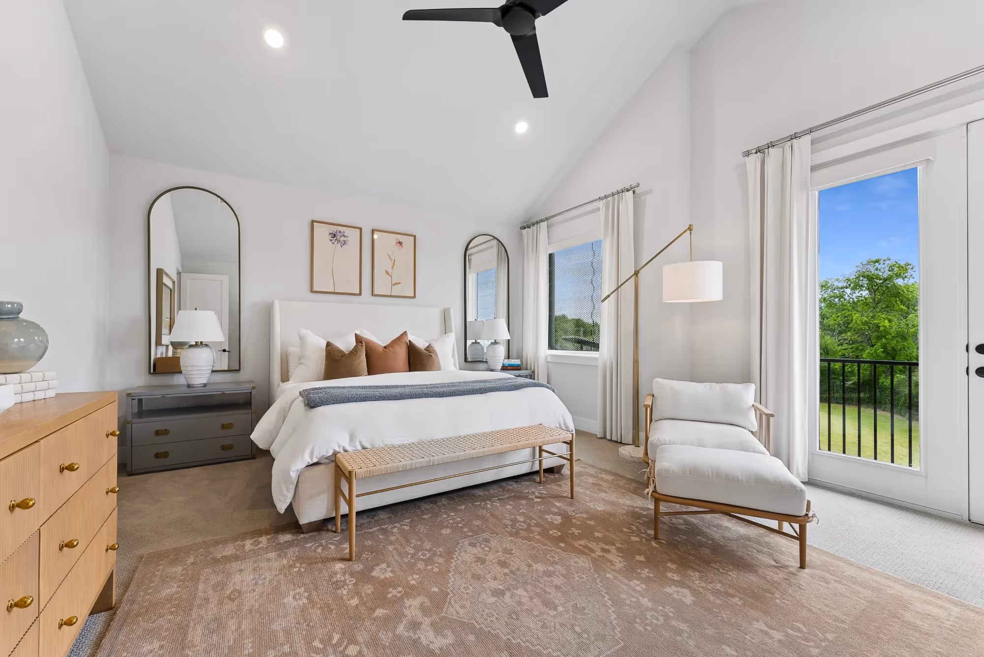 Bright bedroom with arched mirror and patio door
