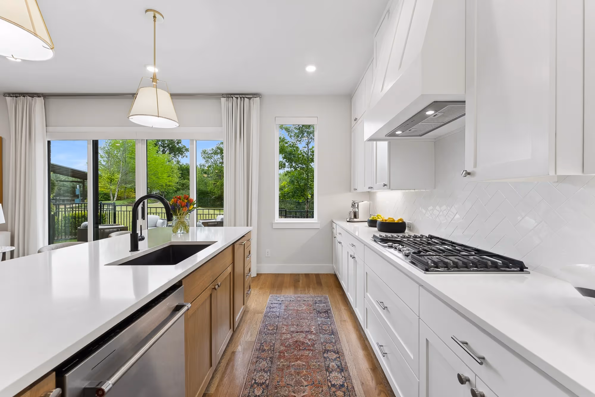 Bright white kitchen with island and pendant lights