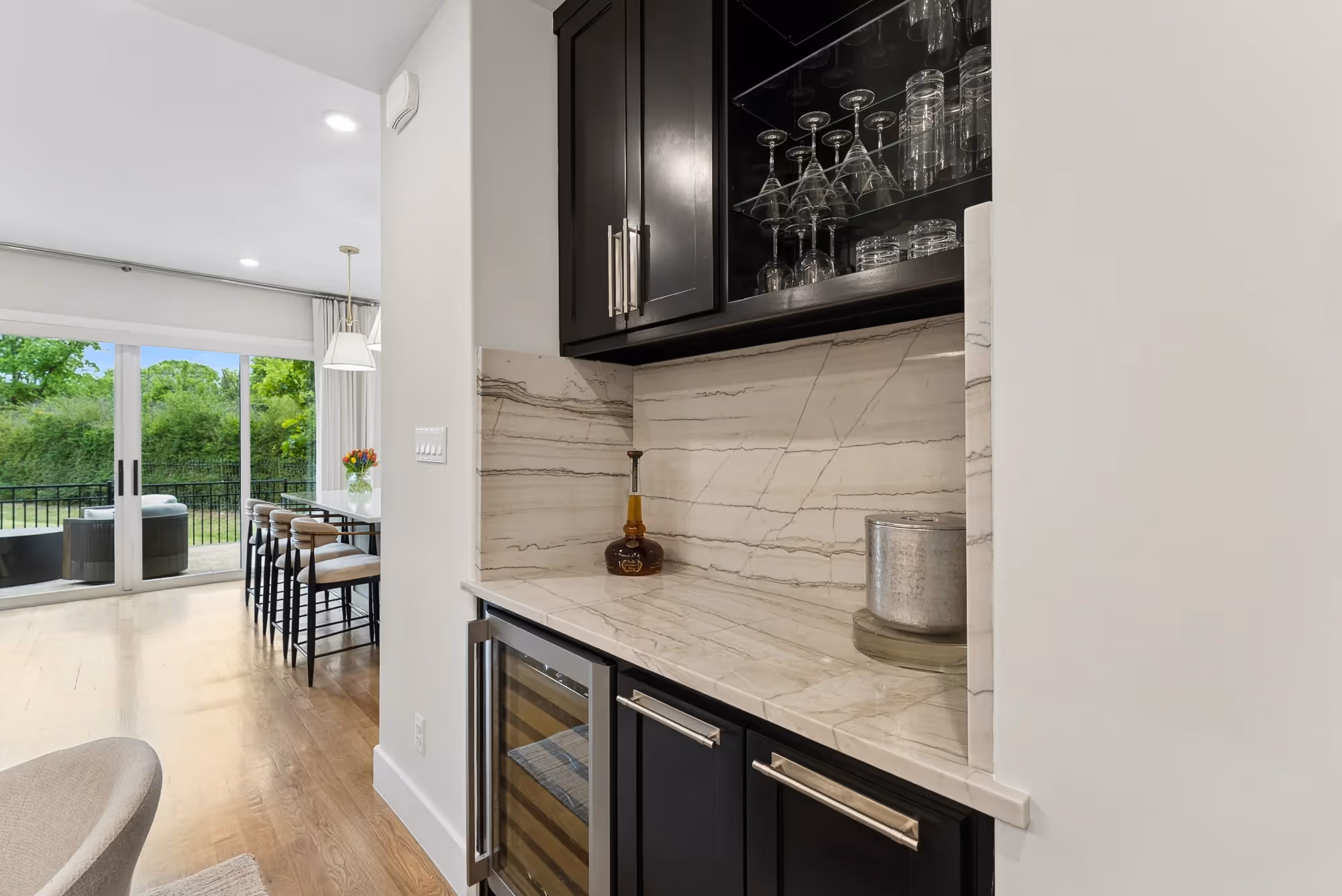 Home bar area with wine fridge and wall-mounted TV