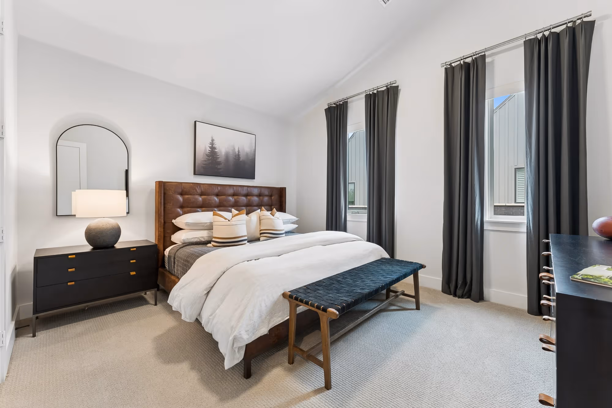 Bright bedroom with white bedding and dark curtains
