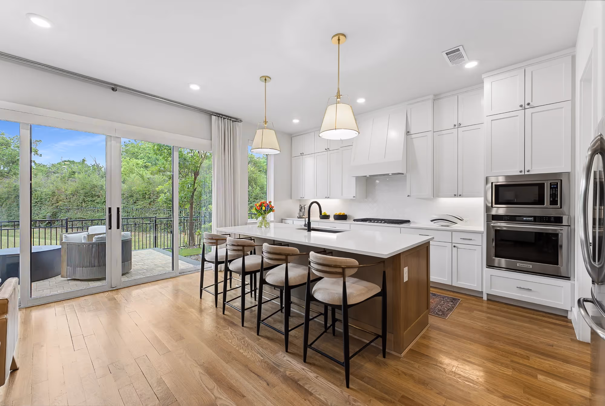 Bright white kitchen with island seating and pendant lights