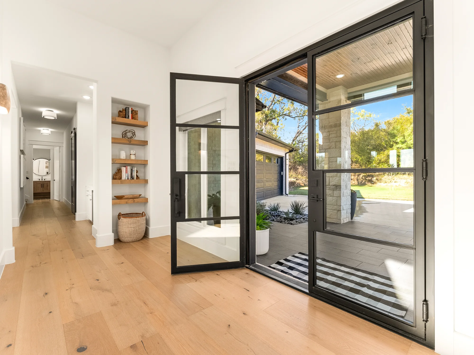 Bright entryway with open glass front door