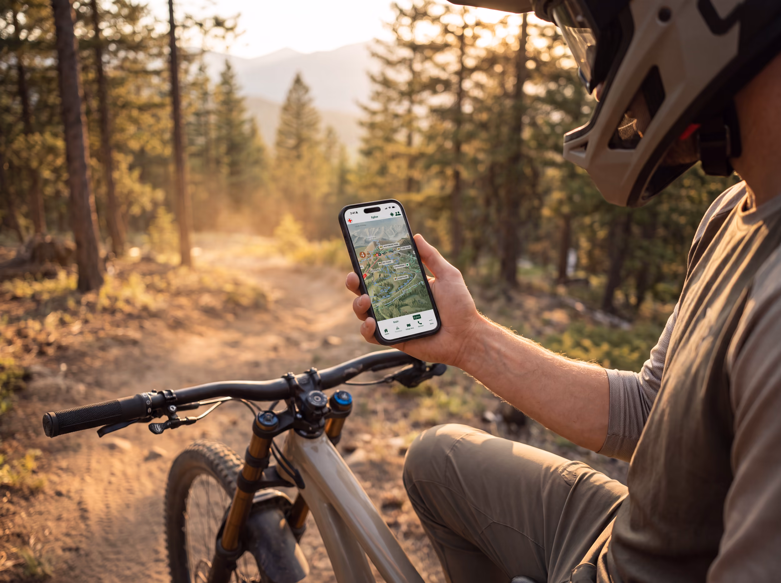A mountain biker checking the digital version of the map on a phone