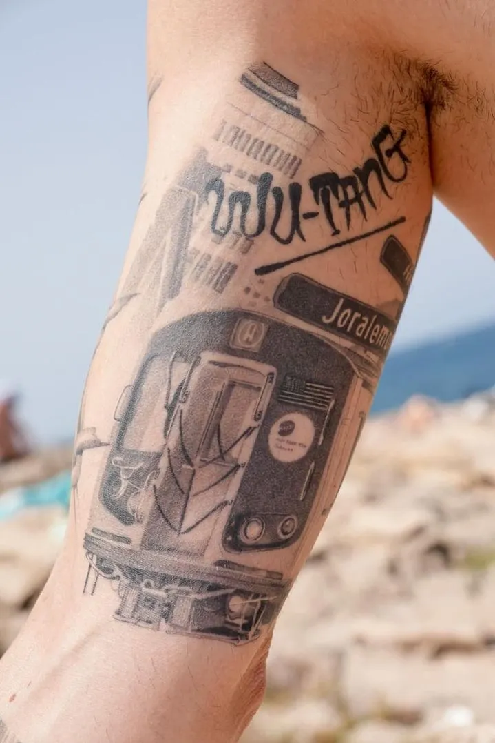 Tattoo on hand featuring a detailed, shaded face with an eye design and white highlights.