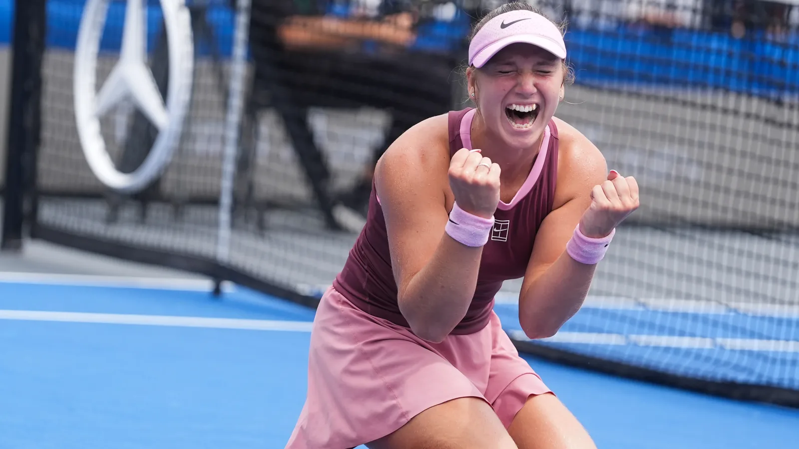 Kristina Liutova screams in celebration on her knees after winning the Memphis Classic