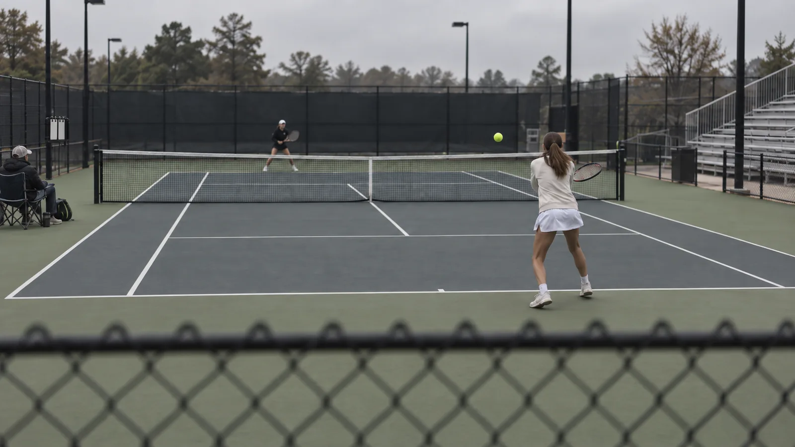 Tennis player in back court as opponent awaits shot