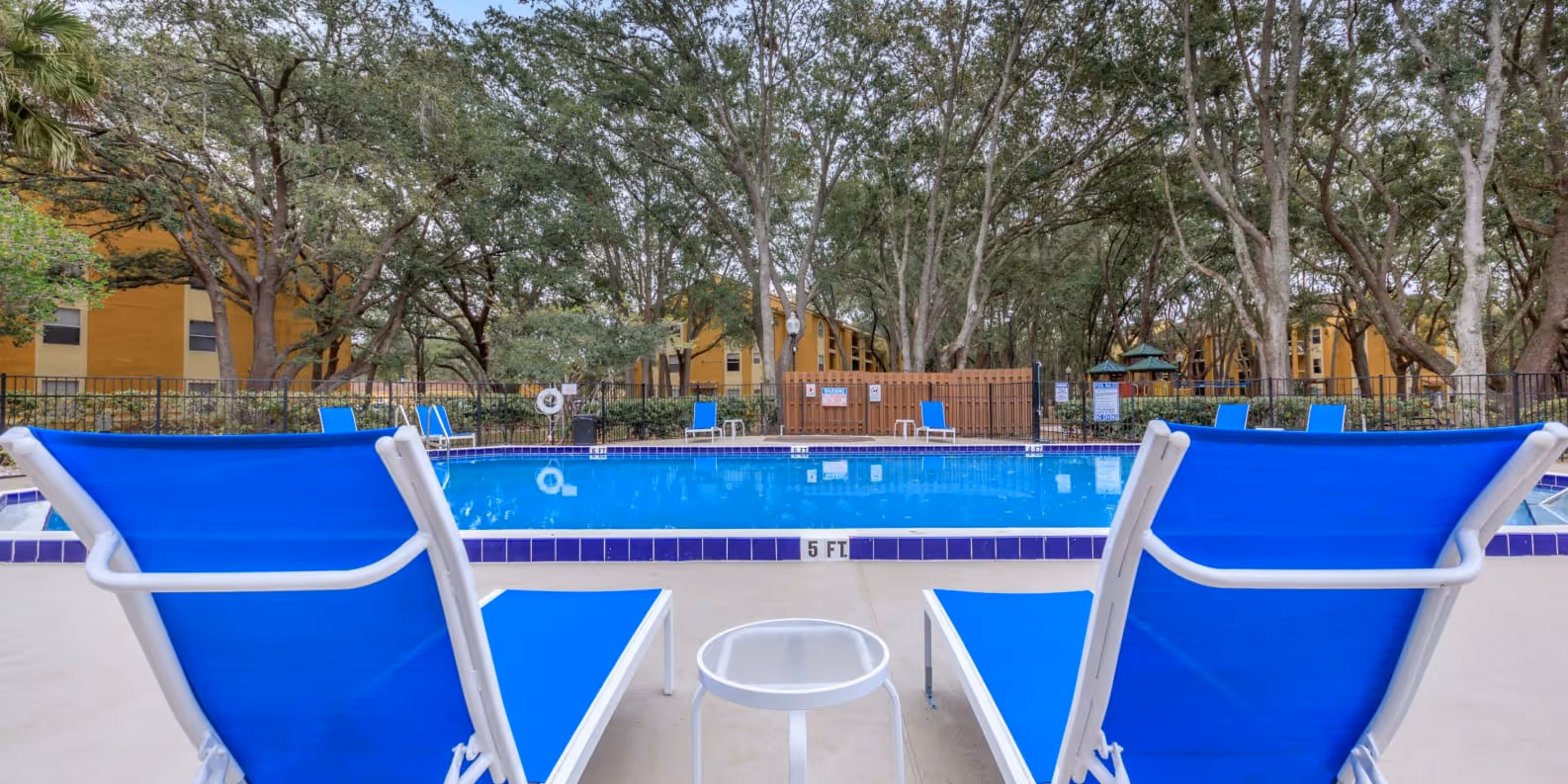 Swimming pool with view of exterior and trees