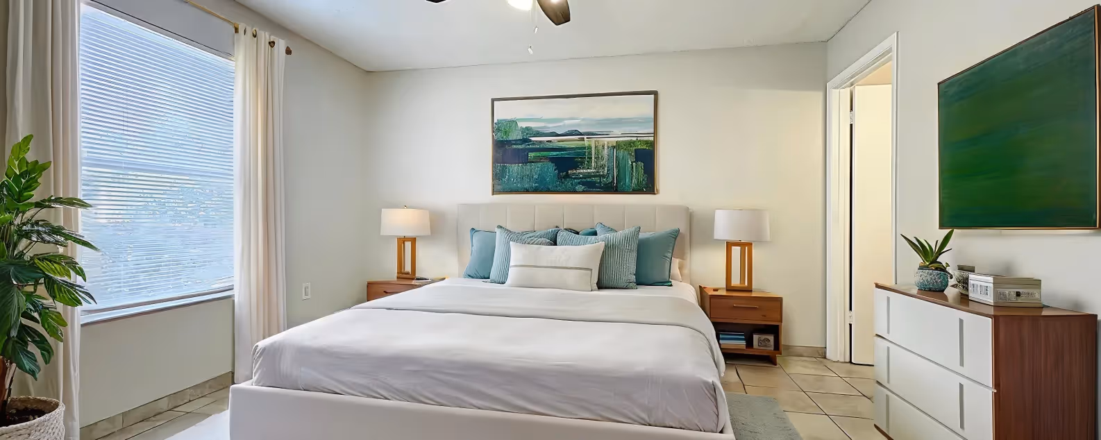 Bedroom with virtually staged furniture including bed, bedside table, and dresser