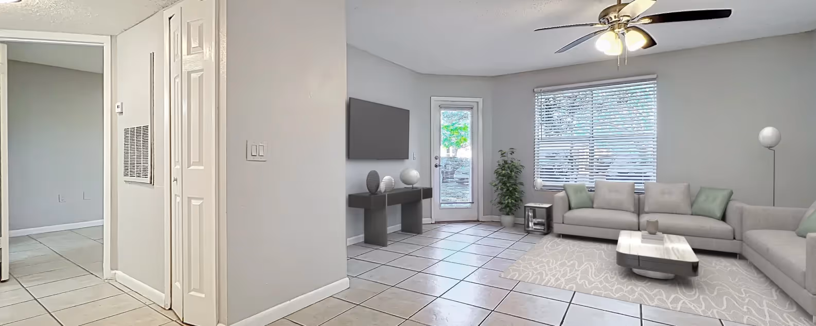 Virtually staged living area with sofa, and large window