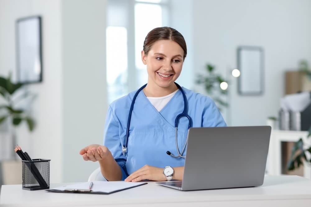 Telemedicine. Doctor having video call with patient via laptop indoors