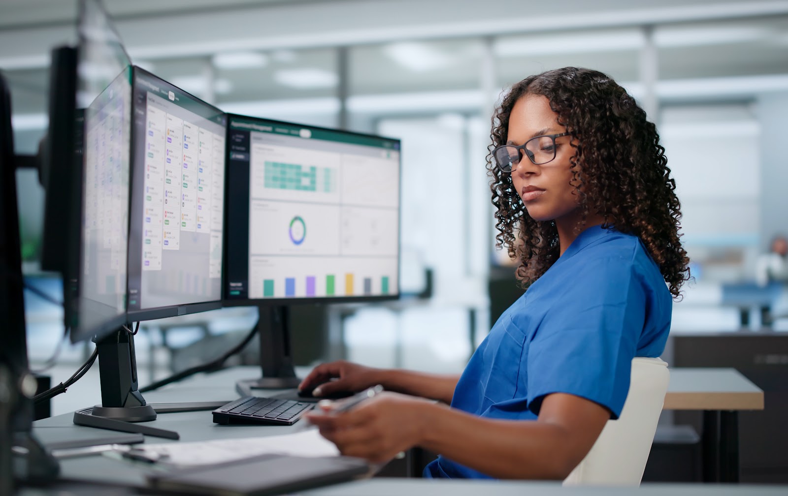 Healthcare professional working with clinical data and technology systems