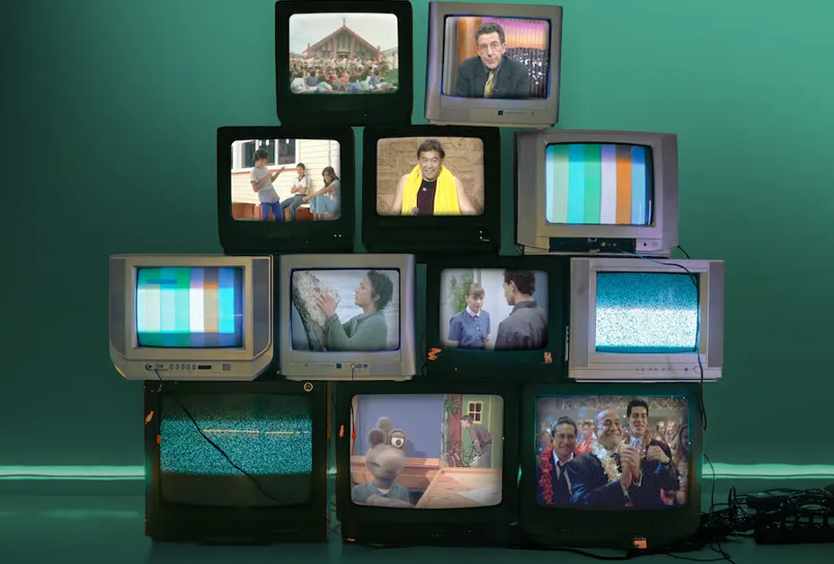 Stack of vintage TVs showing classic New Zealand film and TV scenes against a teal wall