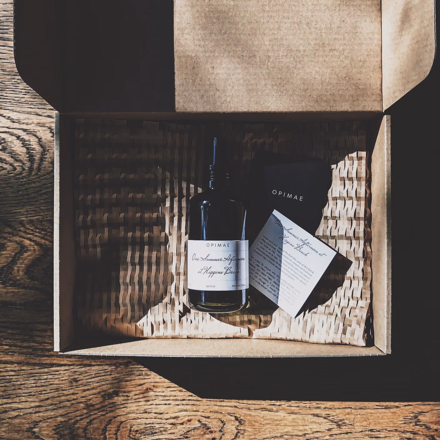 Opimae bottle in a shipping box with guide card