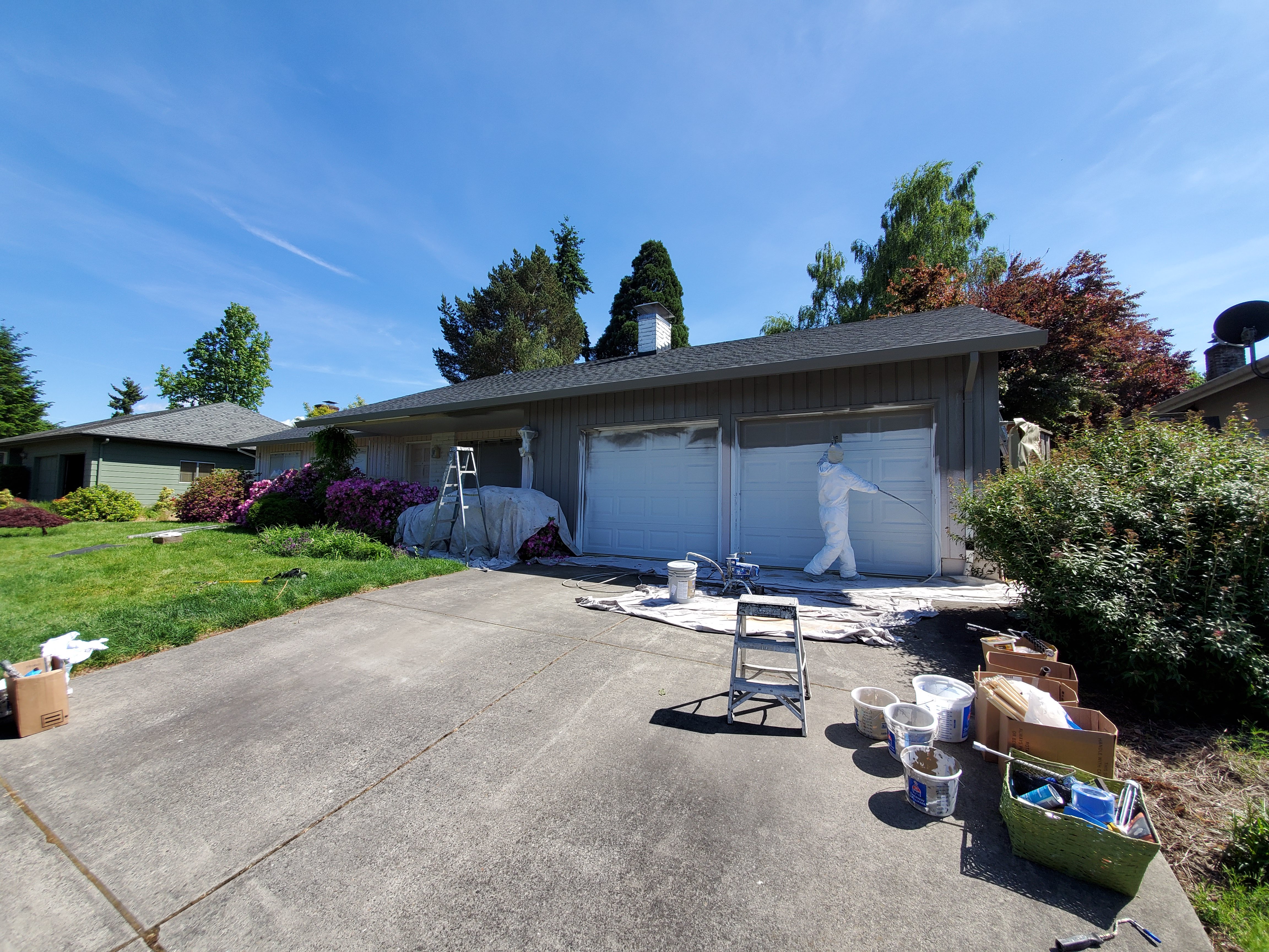 D'S Painting LLC painter on ladder working on residential exterior siding in Oregon