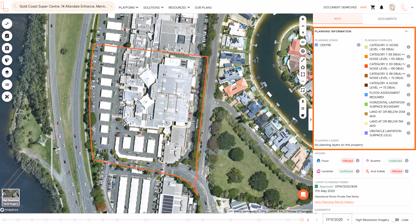 Aerial map showing a commercial center outlined in red beside a highway and residential canal area, with planning info panel.