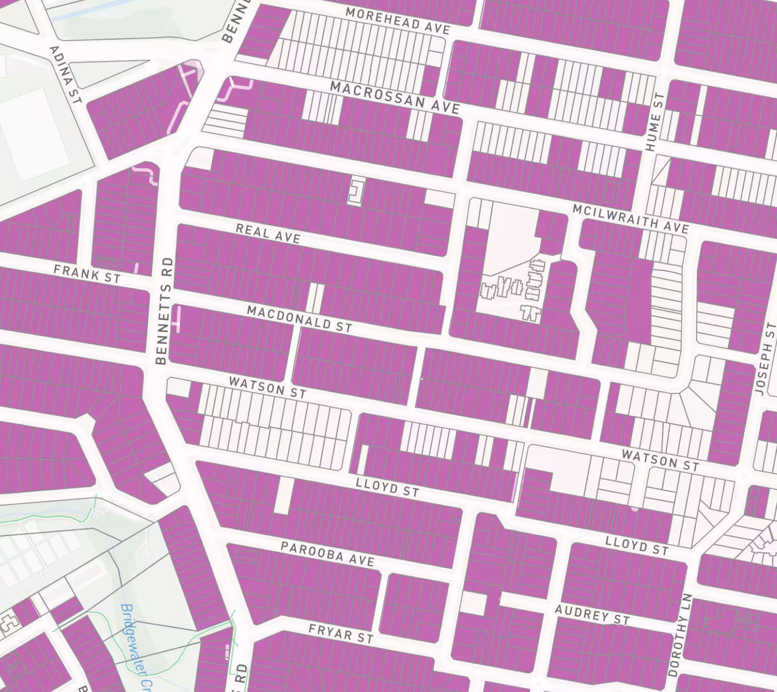 Map of a neighborhood showing streets and colored property plots in purple and white.