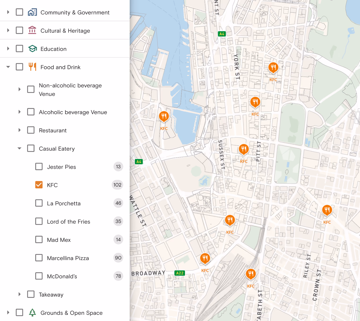 Map showing locations of KFC casual eatery on a city street grid with checkboxes for filtering points of interest categories including Community & Government, Cultural & Heritage, Education, Food and Drink with subcategories like Non-alcoholic beverage Venue, Alcoholic beverage Venue, Restaurant, Casual Eatery including Jester Pies, KFC, La Porchetta, Lord of the Fries, Mad Mex, Marcellina Pizza, McDonald's, Takeaway, and Grounds & Open Space.