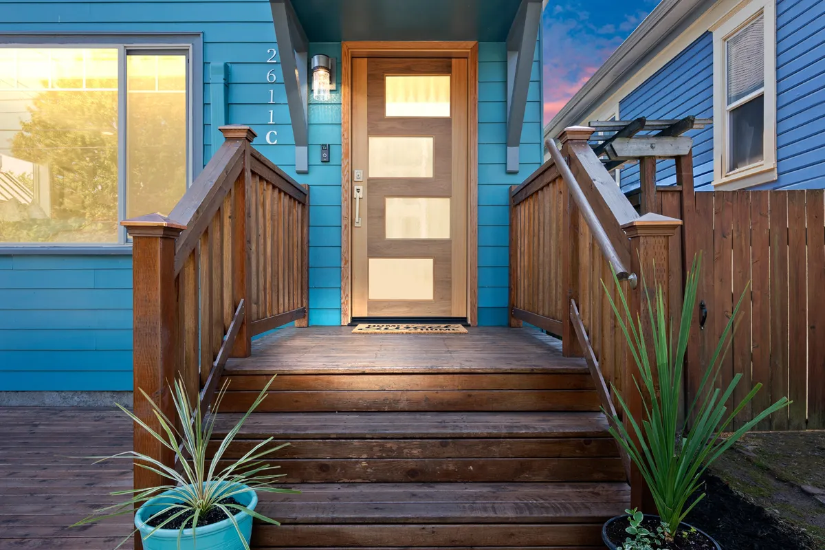 a modern wooden door on a front porch