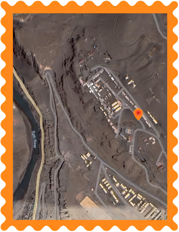 Satellite view of a rugged area with roads and buildings near a river named Spiti River.