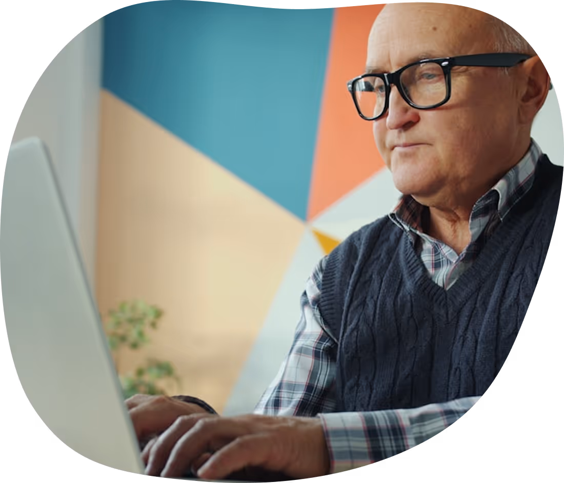 Older man using a computer during stroke recovery therapy