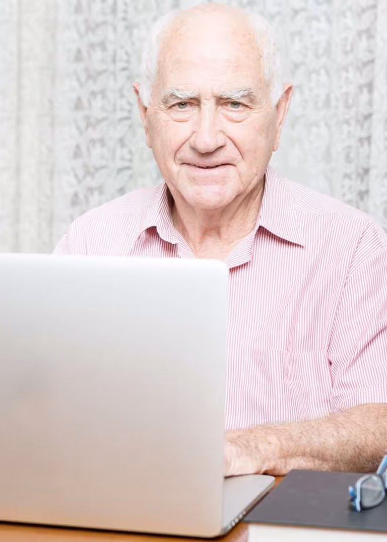 Stroke survivor using a laptop during rehabilitation