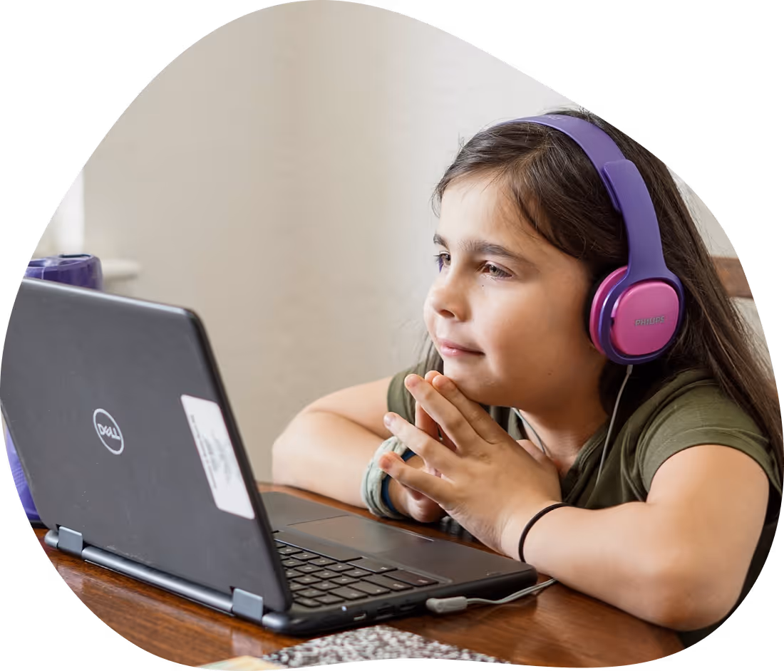 Student with autism using a laptop and headphones for learning support