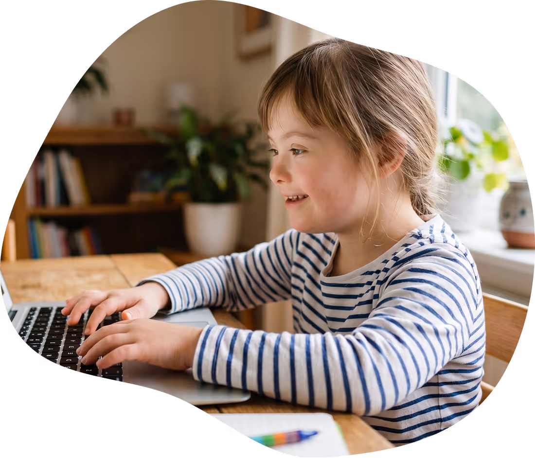 Student with Down syndrome using a laptop for literacy support