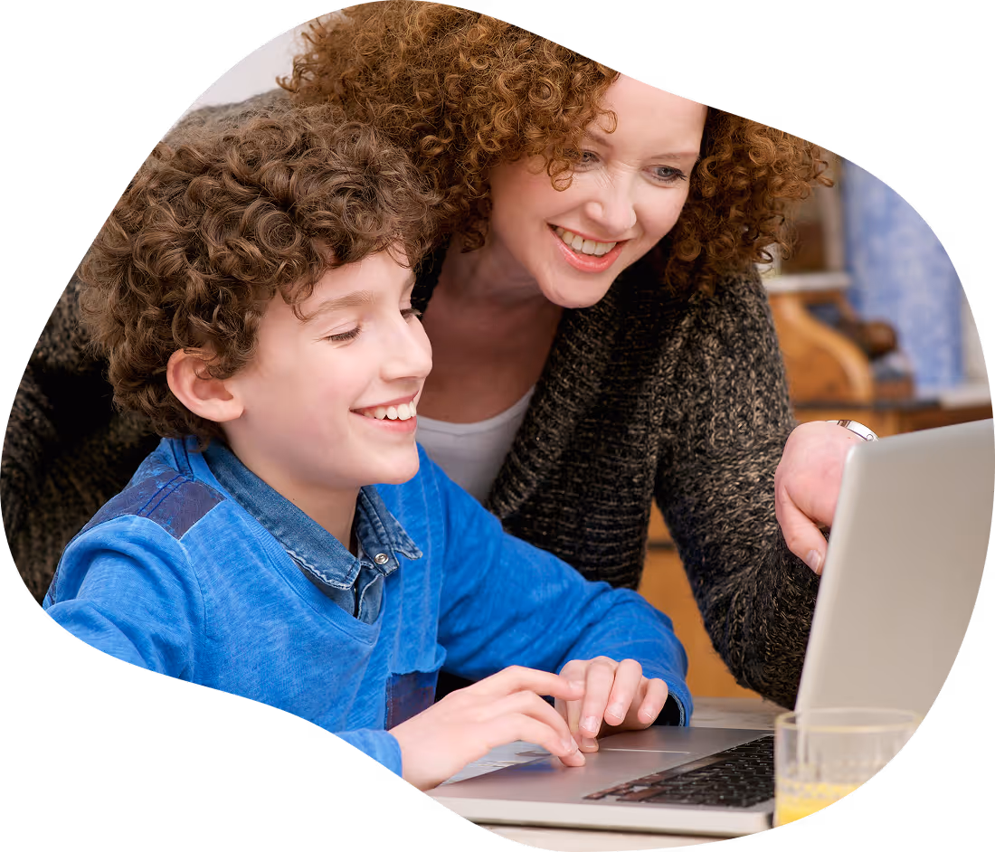 Parent helping a child use Touch-type Read and Spell on a laptop