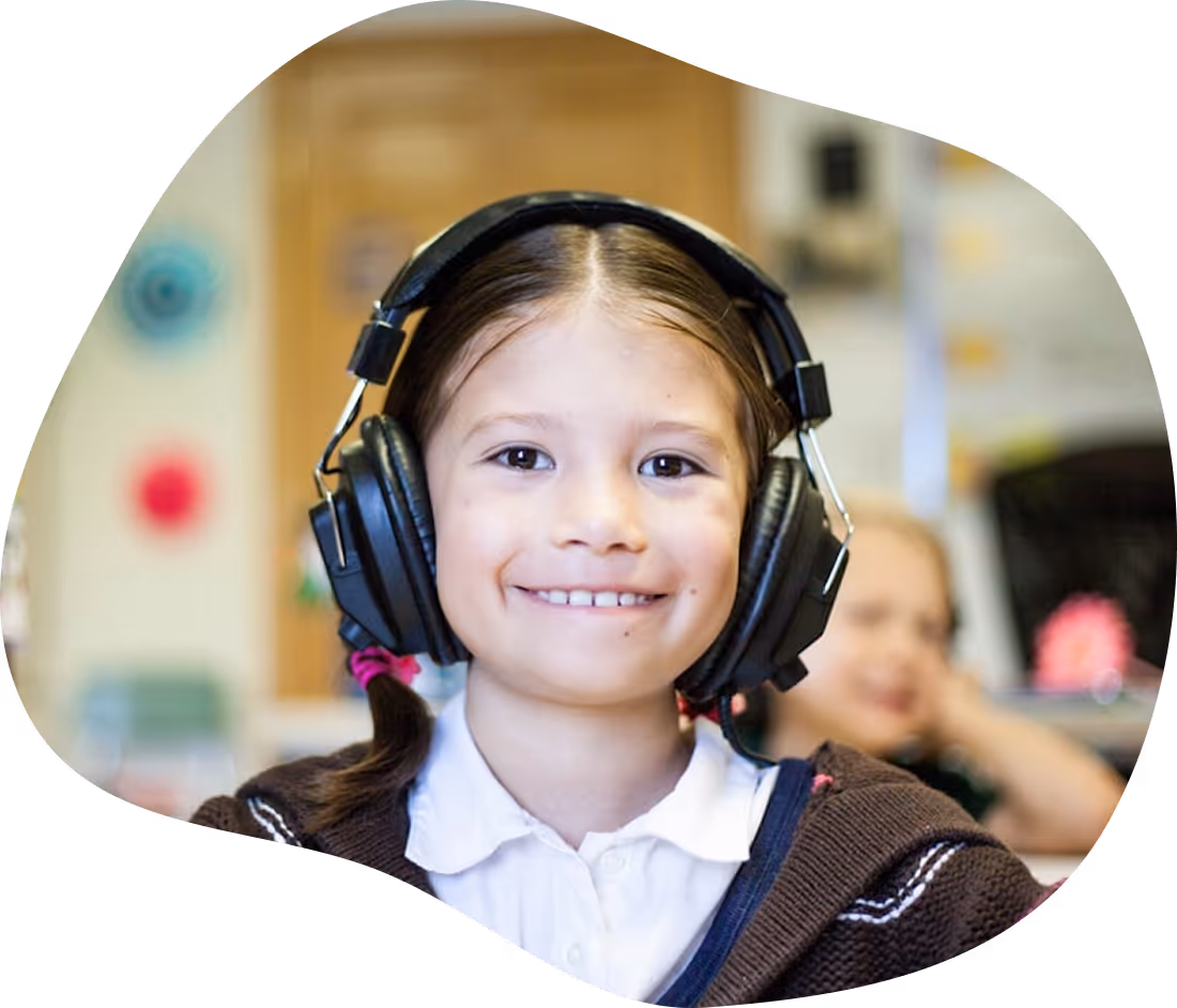 Young student wearing headphones while using a literacy support program