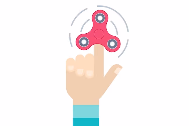 Symptoms of ADD and ADHD - hand holding a fidget spinner