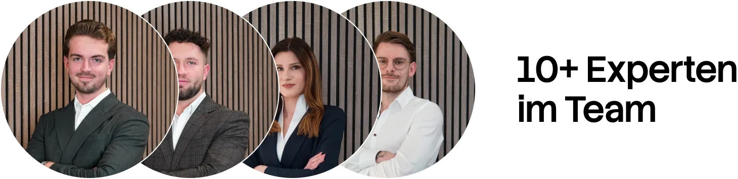 Four professionals in business attire posing with arms crossed against a vertical wooden slat background.