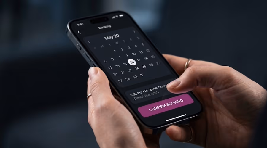 Person holding phone showing May 20 booking with Dr. Sarah Chen and confirm booking button.