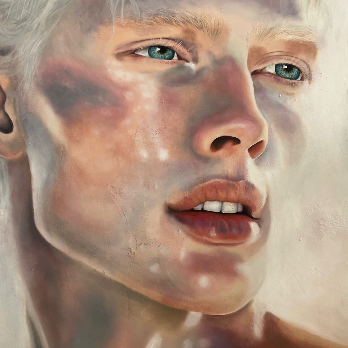 Nahaufnahme eines realistischen Gemäldes eines jungen Gesichts mit blauen Augen und leicht geöffnetem Mund.