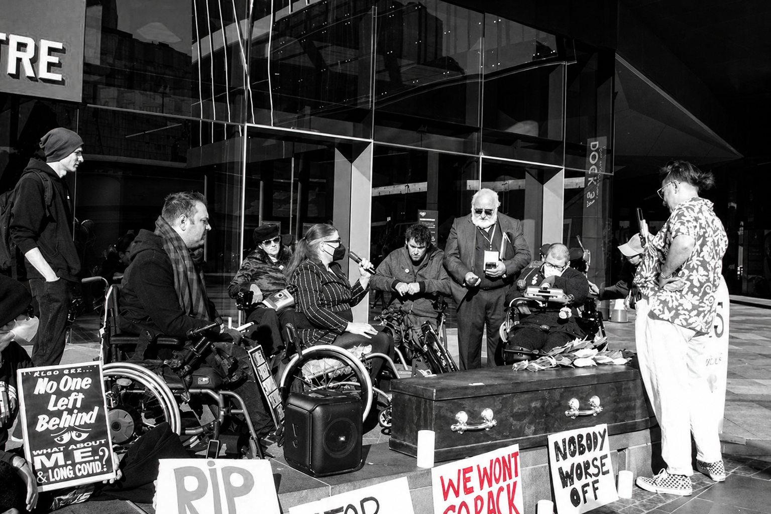 Disabled People Against Cuts Australia protest banner reading We won't go back.