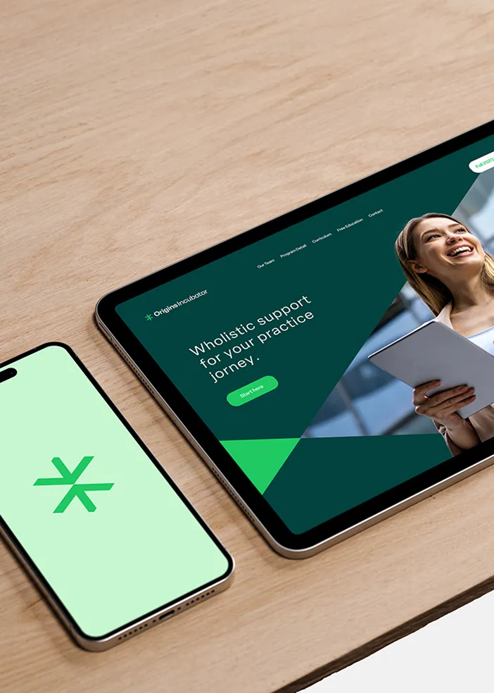 Tablet showing website for holistic practice support and phone with a green star-like logo on screen.