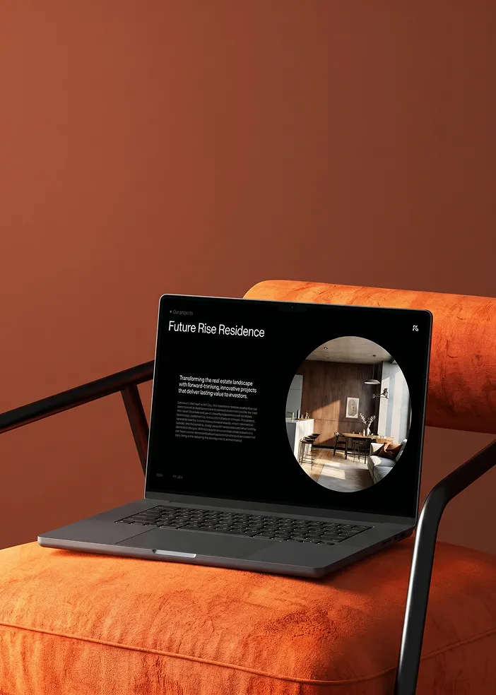 Laptop on orange chair displaying a real estate project called Future Rise Residence with interior design photo.