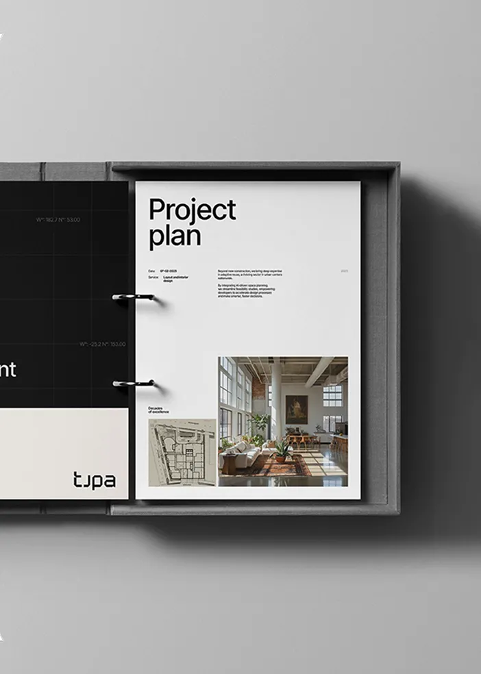 Opened project plan binder showing a page with text, a floor plan, and a photo of a bright modern office space.