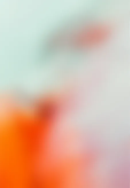 Abstract blurred background with soft pastel colors including orange, green, and pink.