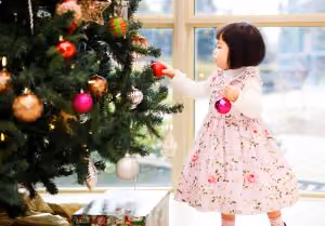 Children decorating a Christmas tree.em of their lost loved one.