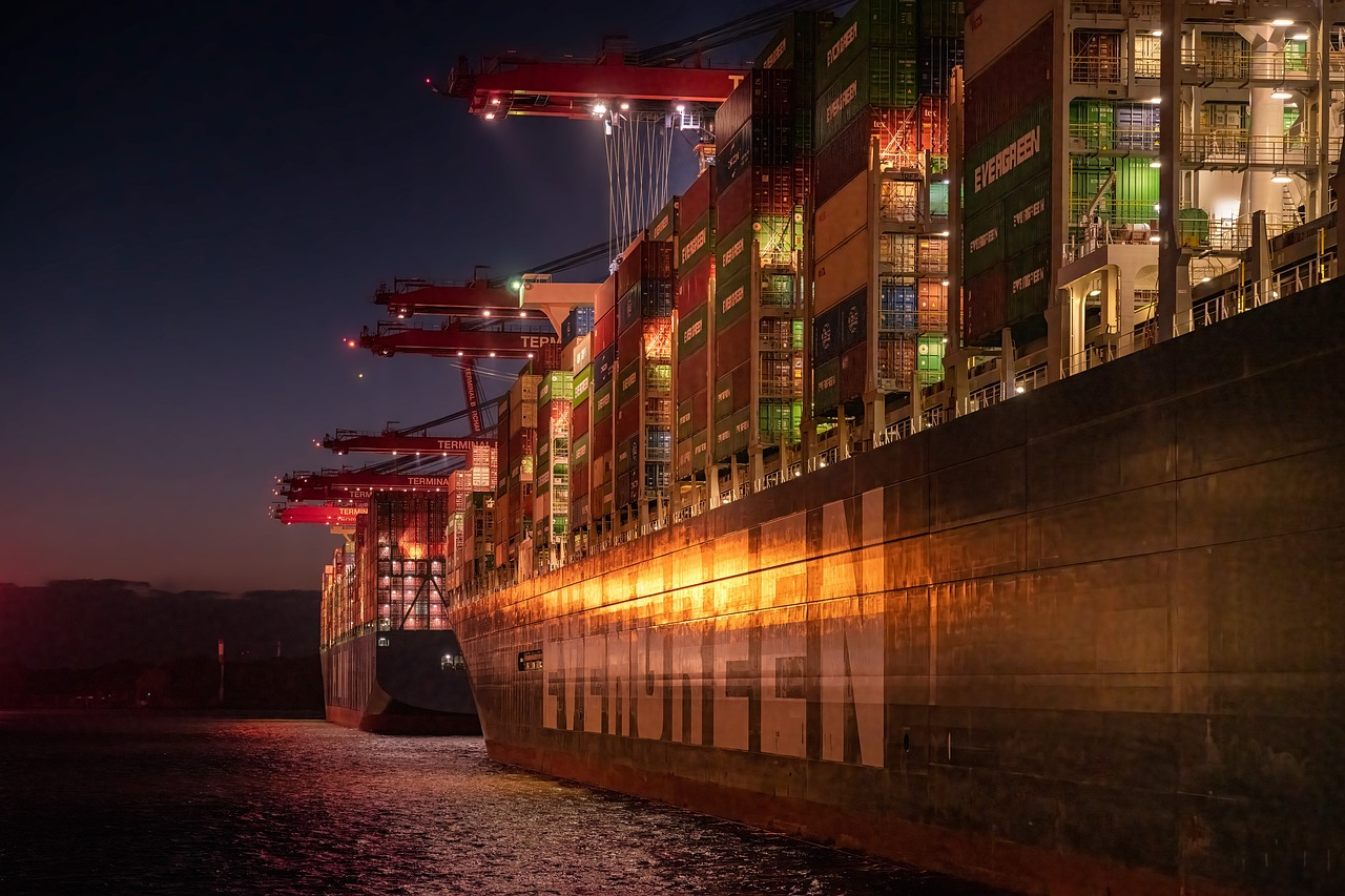 Sideview of massive cargo ship at night.