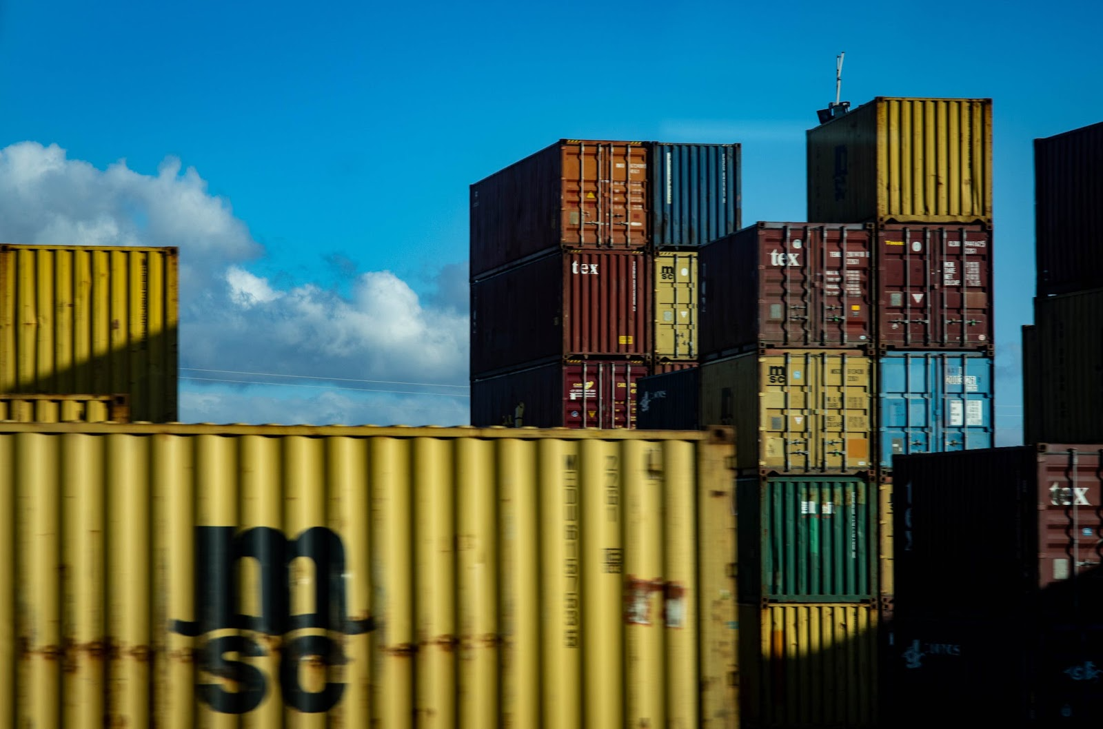 Assorted-colour containers stacked up.