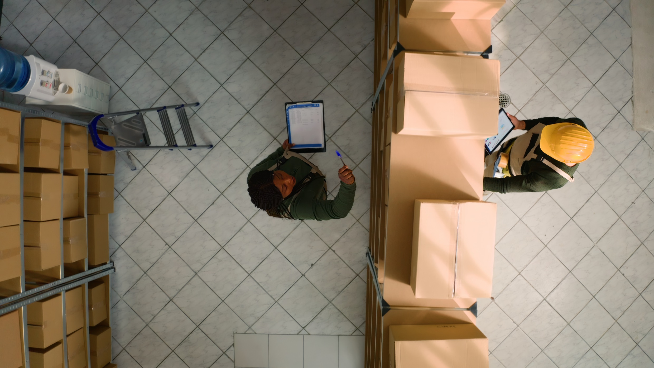 Warehouse coworkers examining parcels