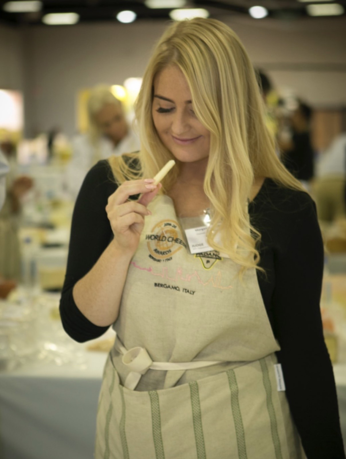Morgan McGlynn Carr judging at the World Cheese Awards in Bergamo, Italy, wearing her official judge apron