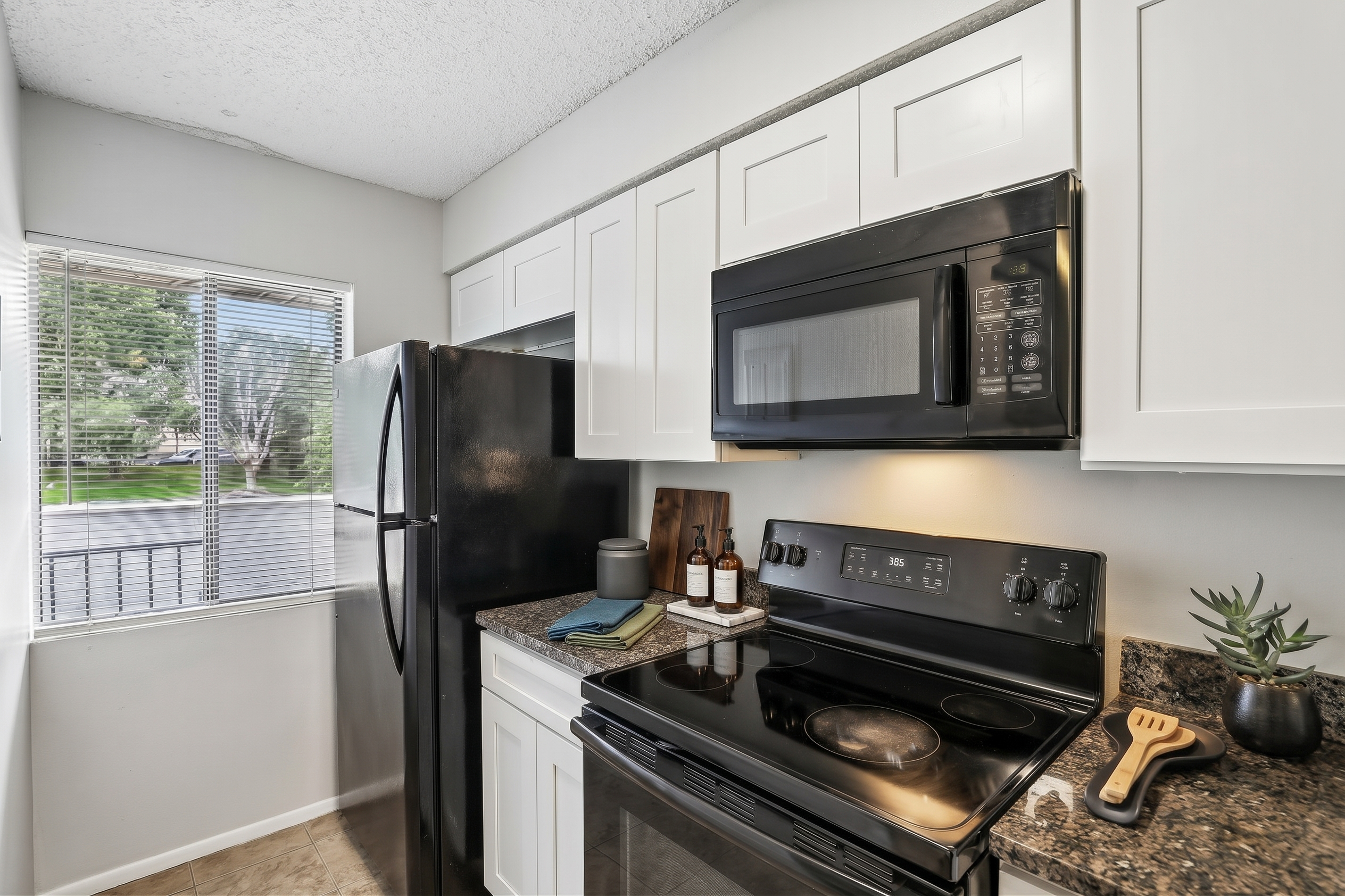 Kitchen area with microwave, refrigerator, and stove.