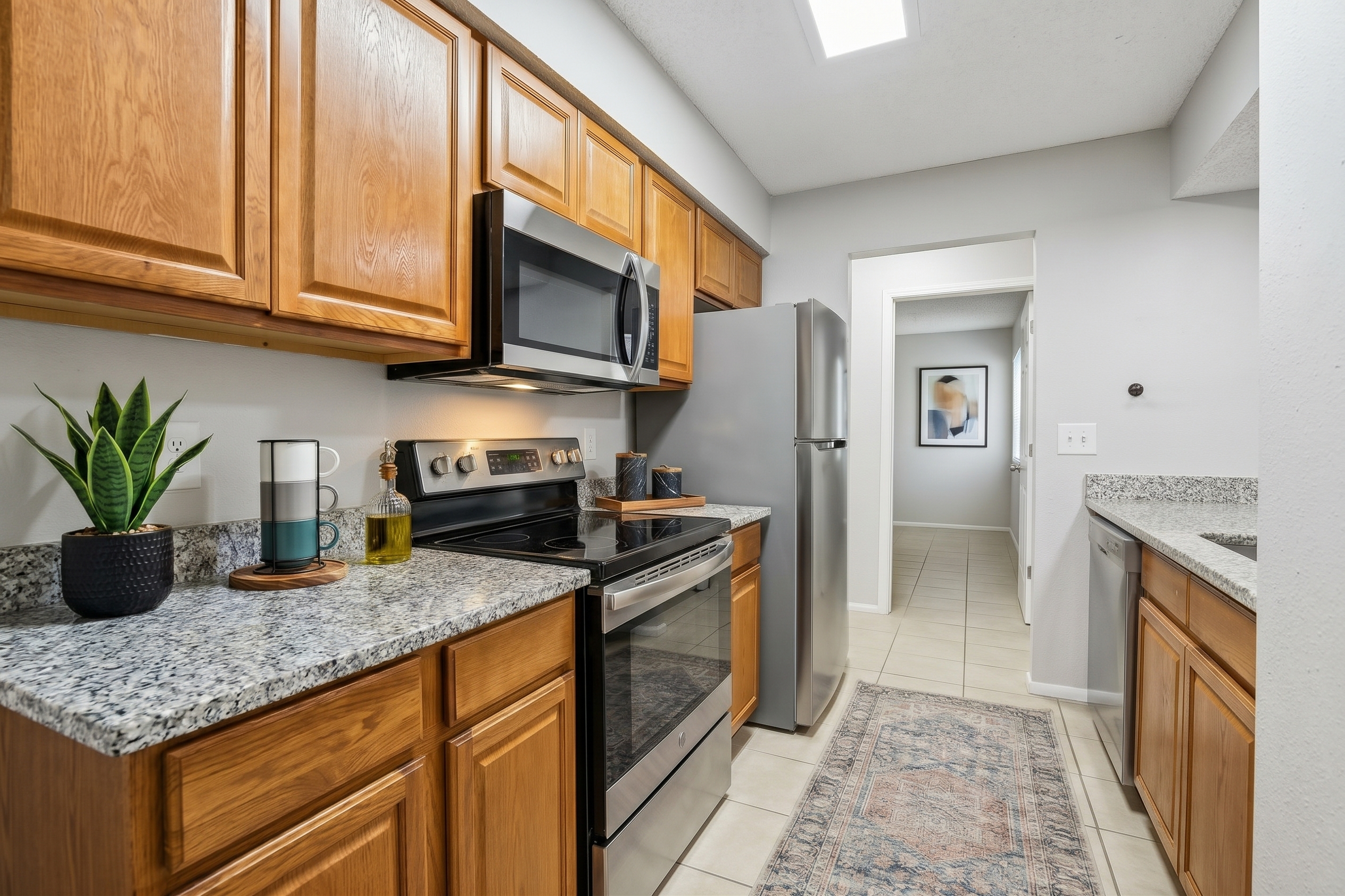 Kitchen with appliances. Stove refrigerator, and microwave.