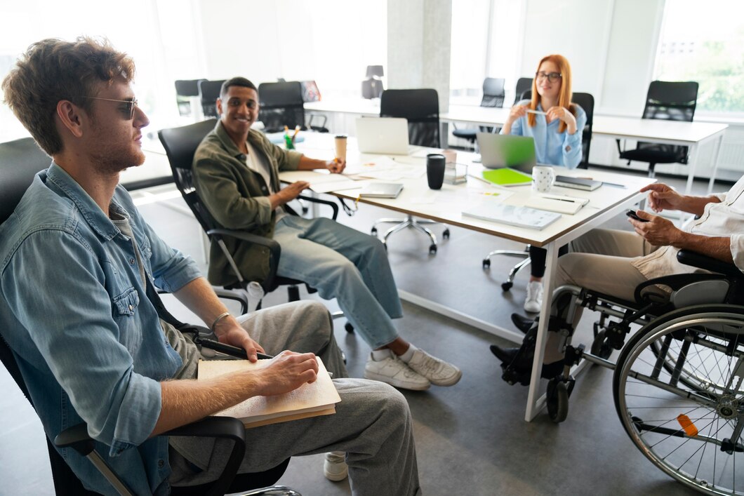 a blind and a disabled man taking part in office discussion