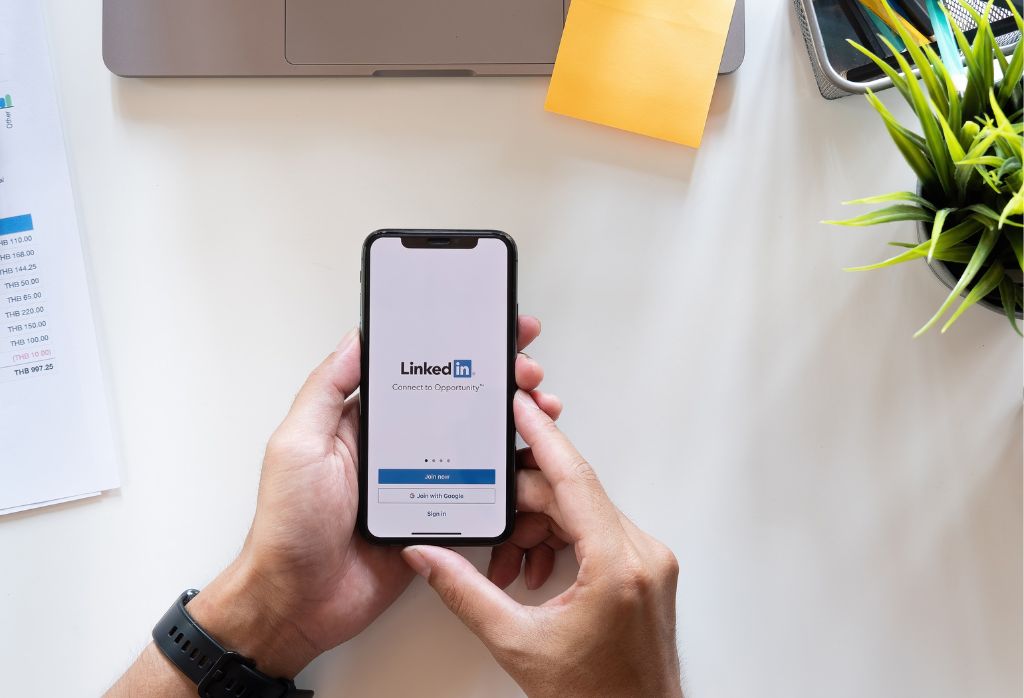 man logging into LinkedIn via smartphone