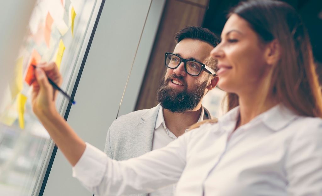 man and a woman discussing a strategy