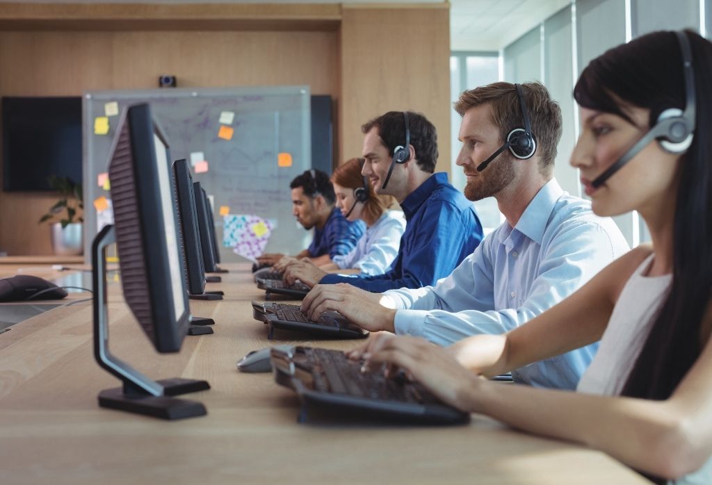 employees with headphones making calls